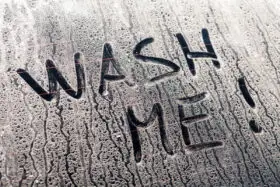 14884396_wash-me-words-on-a-dirty-car-window1